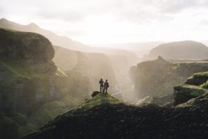 Man standing on cliff overlooking Fimmvorduhals canyon in Southern Iceland